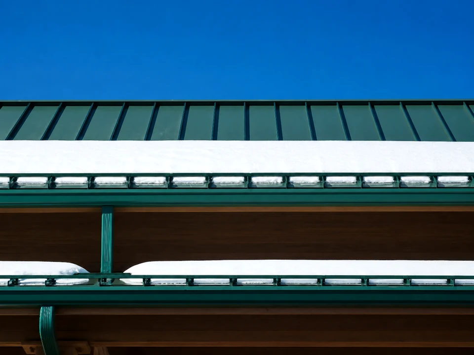 SnoBar snow rail system holding snow on a metal roof
